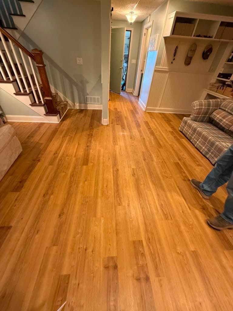 COREtec Norwegian Maple luxury vinyl plank installed through a Berlin basement living area and hallway