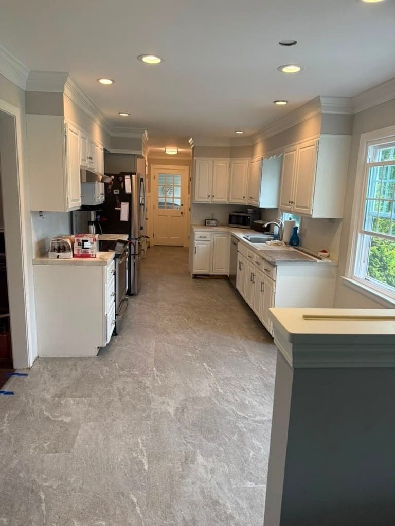 Karndean Art Select Sterling Quartzite flooring in a Kensington kitchen with white cabinetry and a window beside the sink