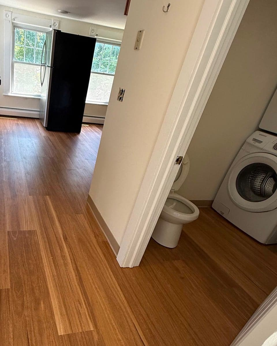 Karndean Lemon Spotted Gum vinyl flooring through an East Hampton kitchen, hallway, and bathroom