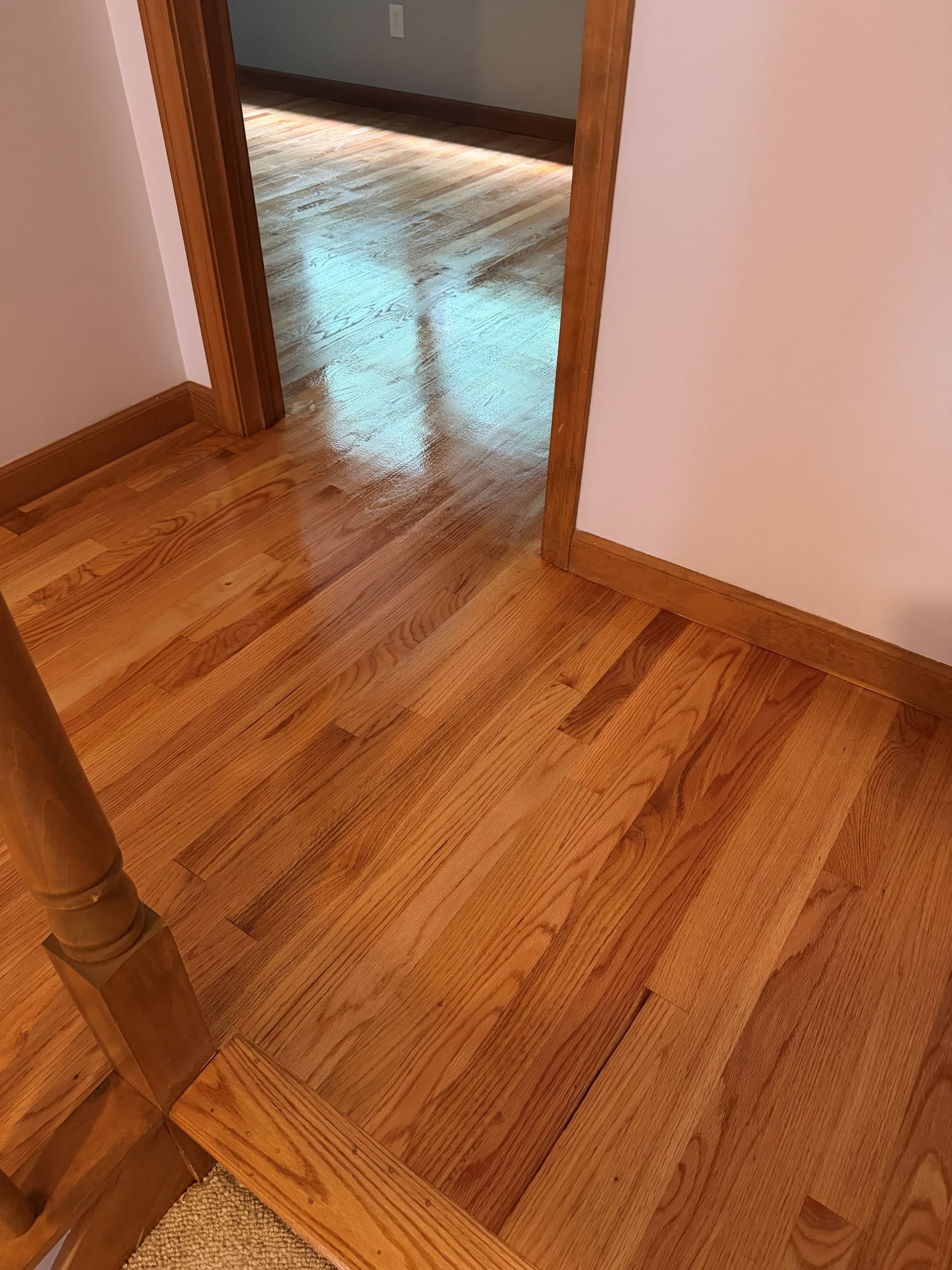 Refinished hardwood at an Enfield stair opening and adjoining bedroom doorway