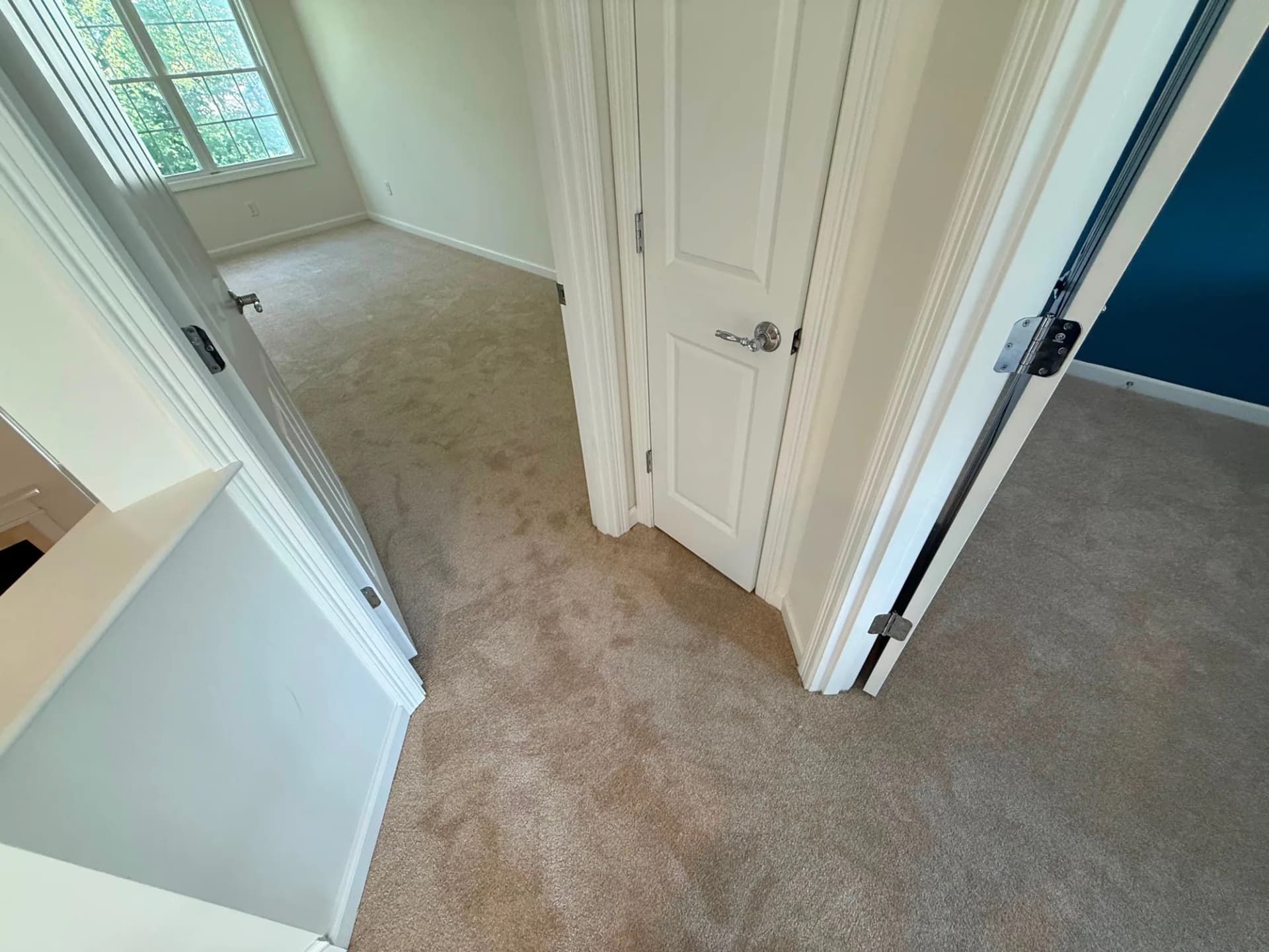 Carpet across an upstairs landing outside the bedrooms in a Newington home