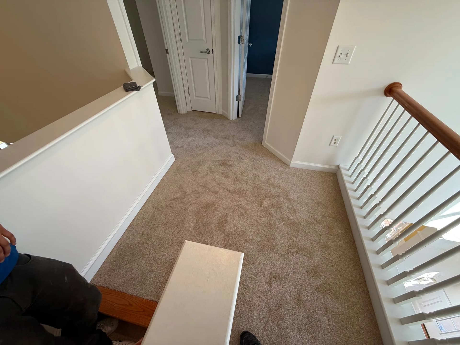 Carpeted upper landing beside the staircase in a Newington home