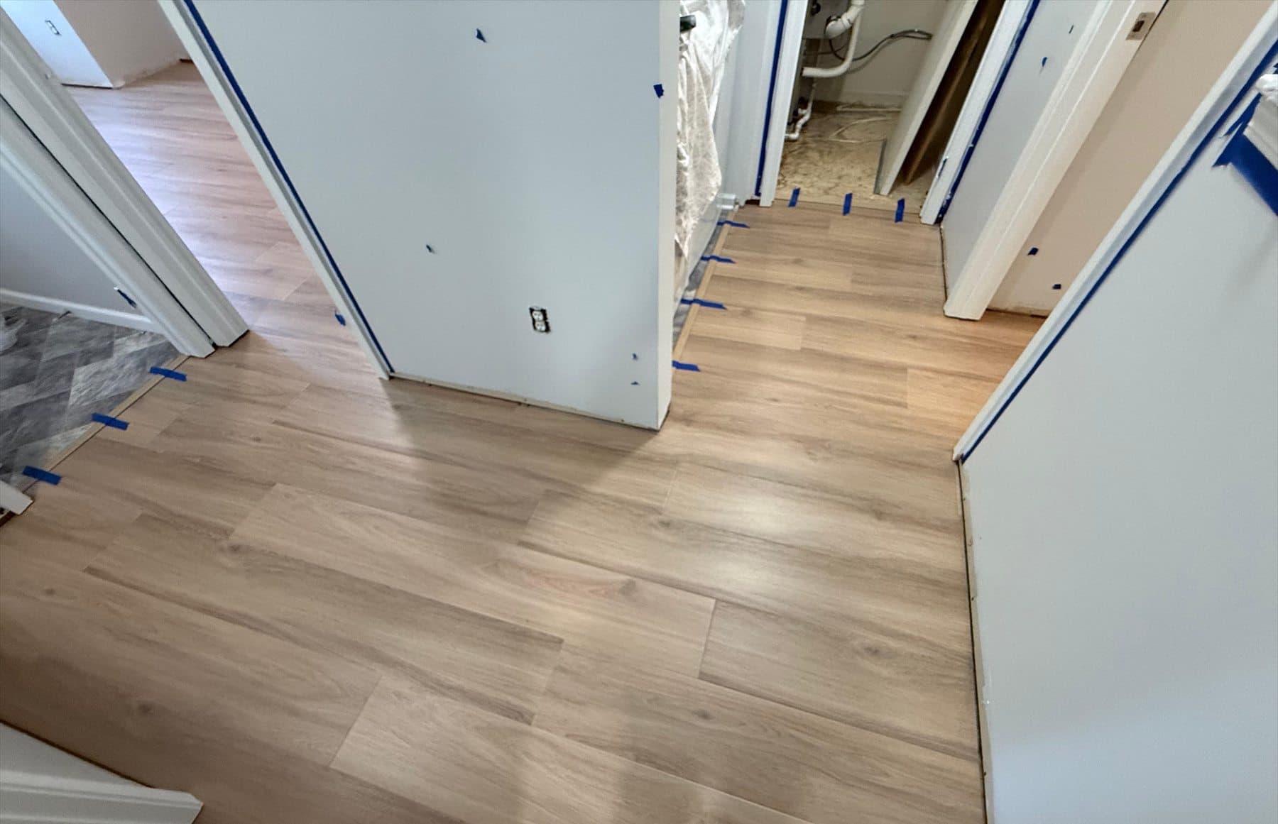 Tarkett ProGen Plus Bespoke Oak Autumn click LVP extending through a Plainville condominium hall during Phase 1