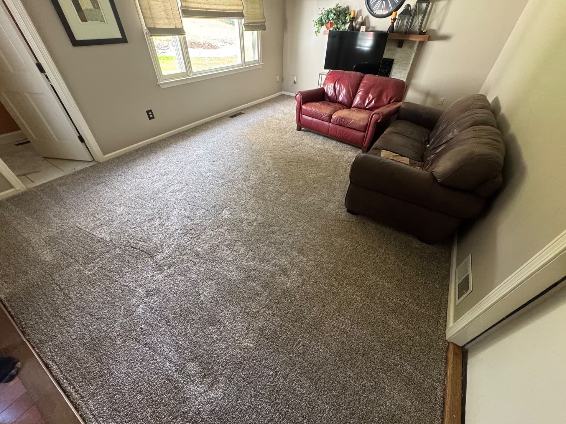 Completed Honeycomb carpet across a Rocky Hill family room with a window, sofas, and adjoining doorways