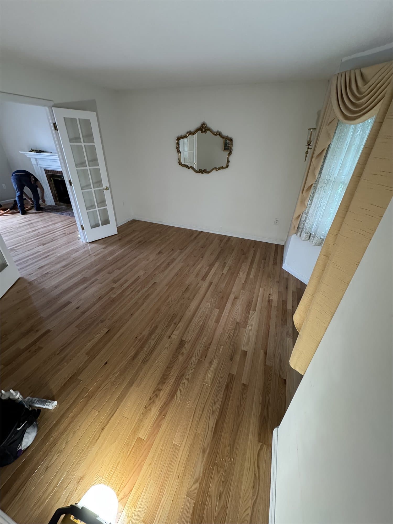 Somerset Natural Red Oak solid hardwood installed across a West Hartford living room with the adjoining family room visible