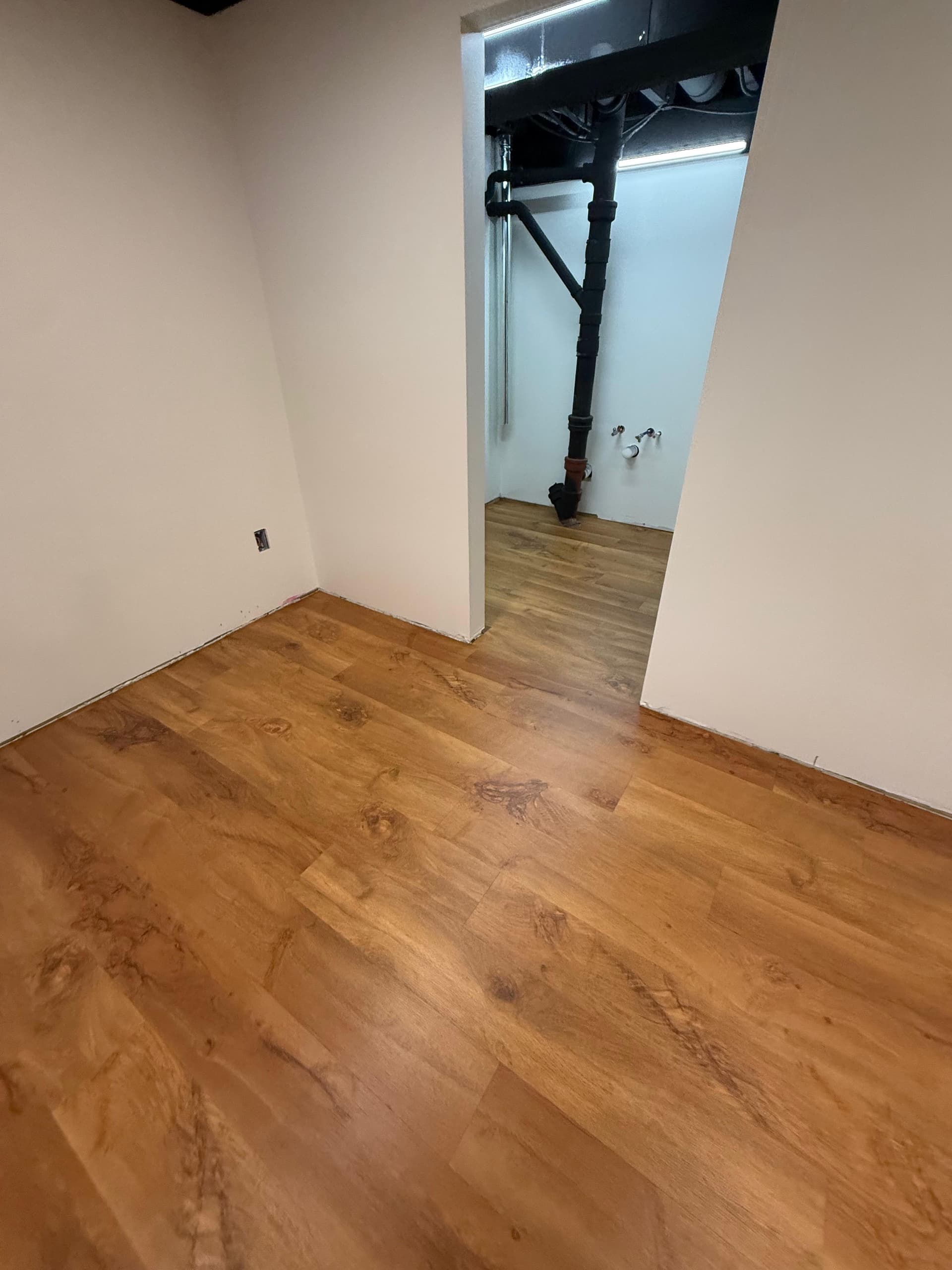 Karndean Wellington Oak flooring continuing through connected finished basement spaces in Wethersfield