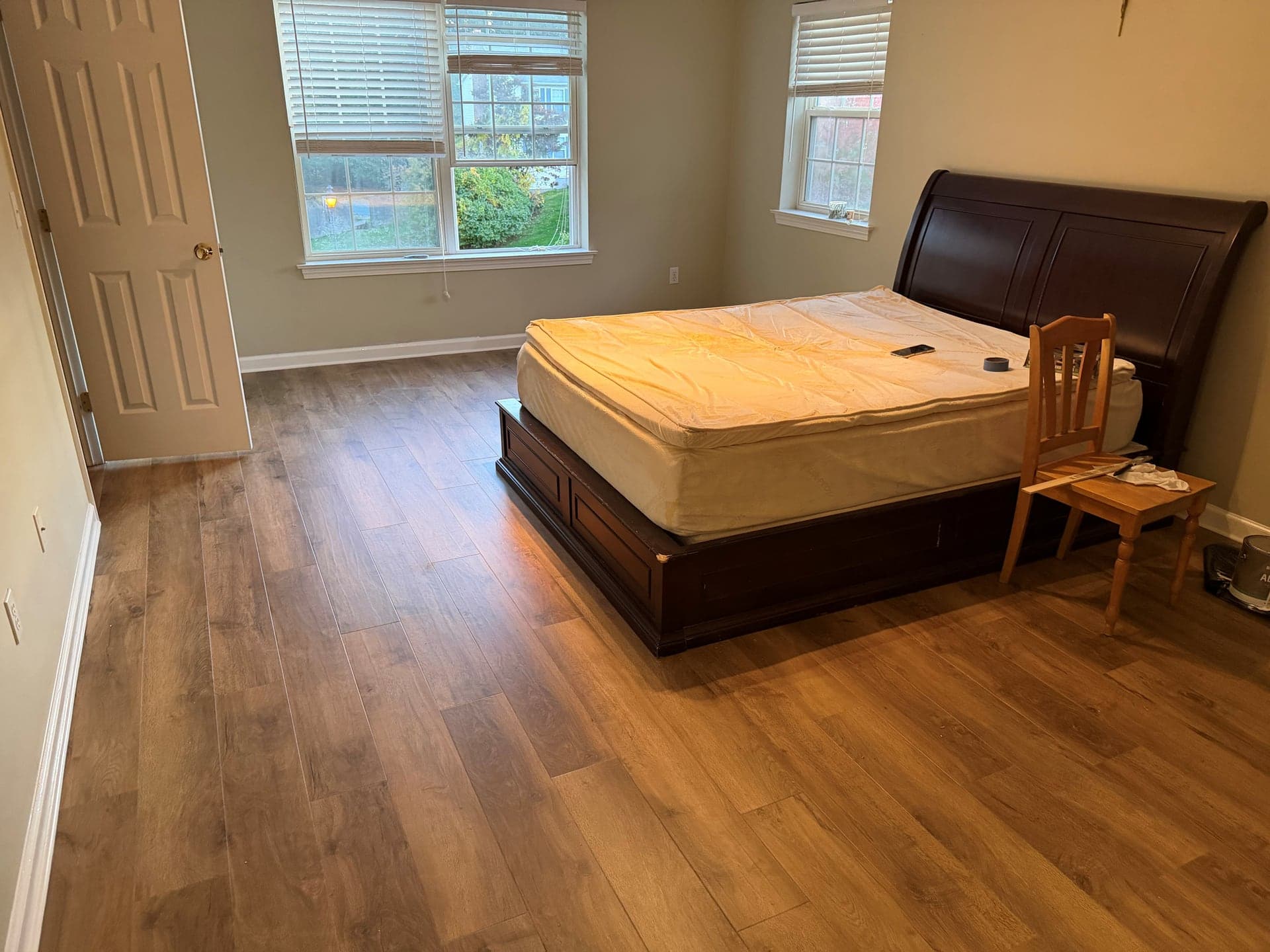 Karndean Salon Oak luxury vinyl plank flooring around a dark wood bed in a Windsor bedroom
