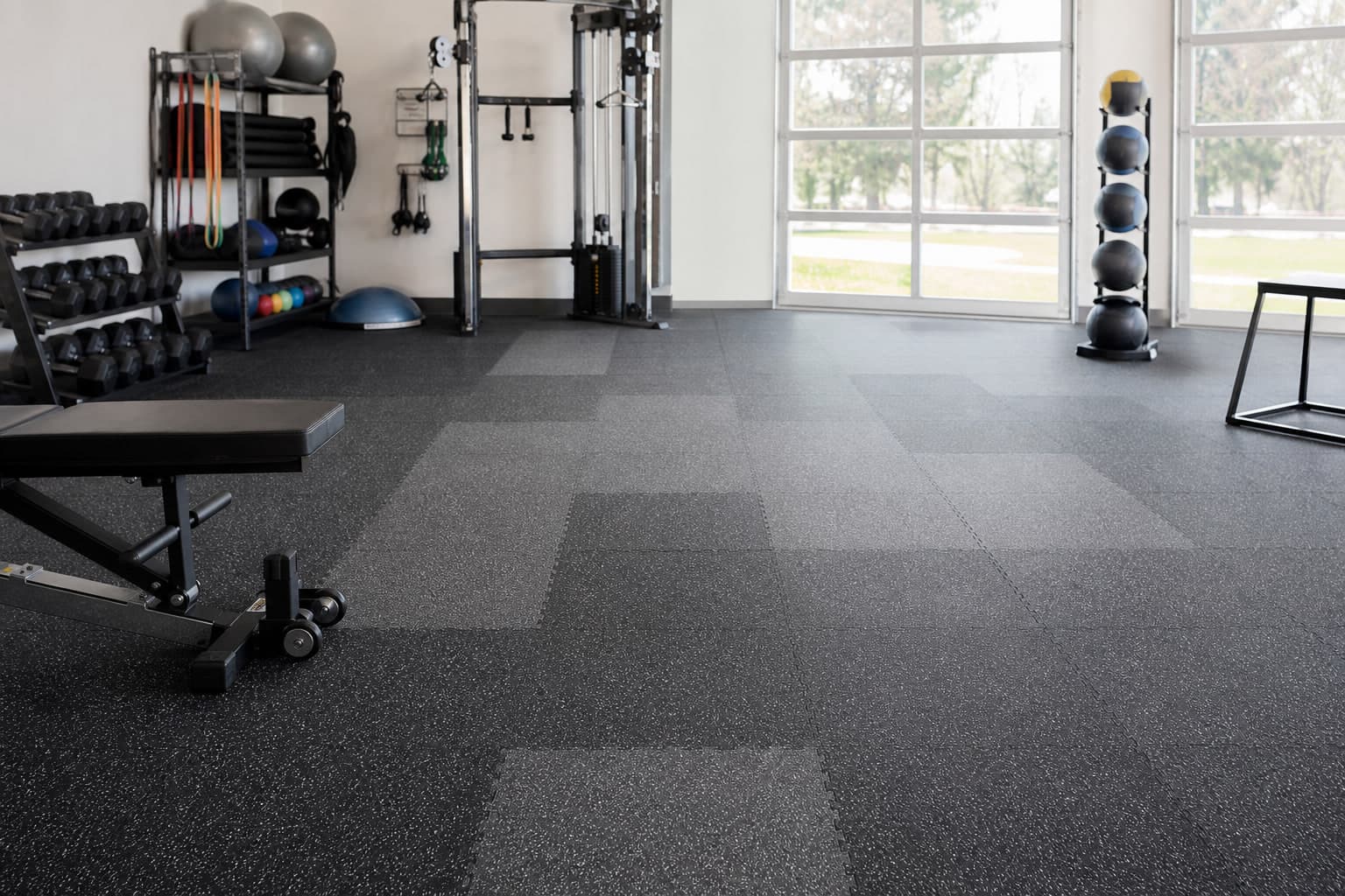 Speckled rubber tile flooring in a commercial fitness studio