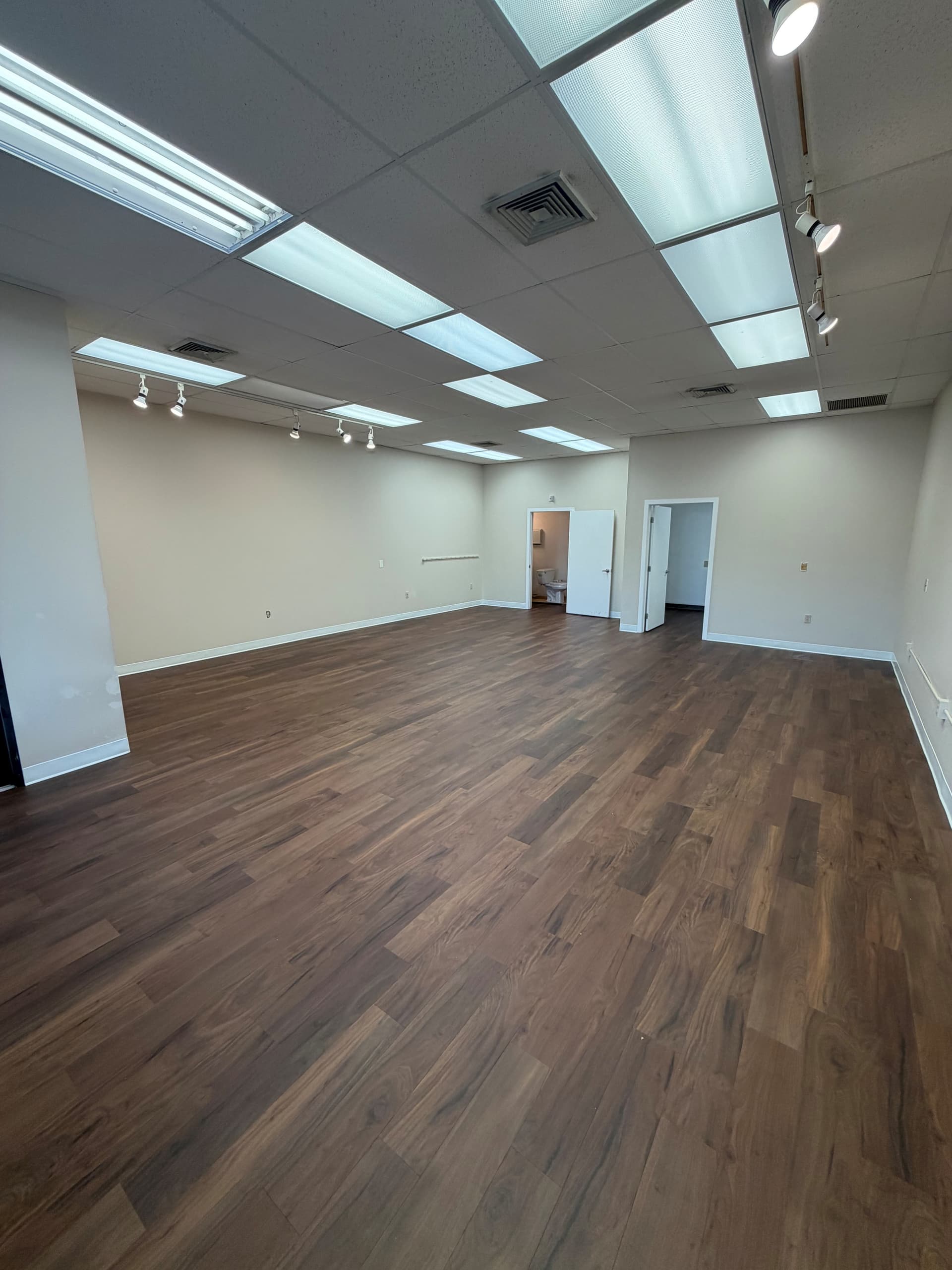 Karndean Opus Natural Walnut gluedown luxury vinyl installed in an open Berlin commercial interior