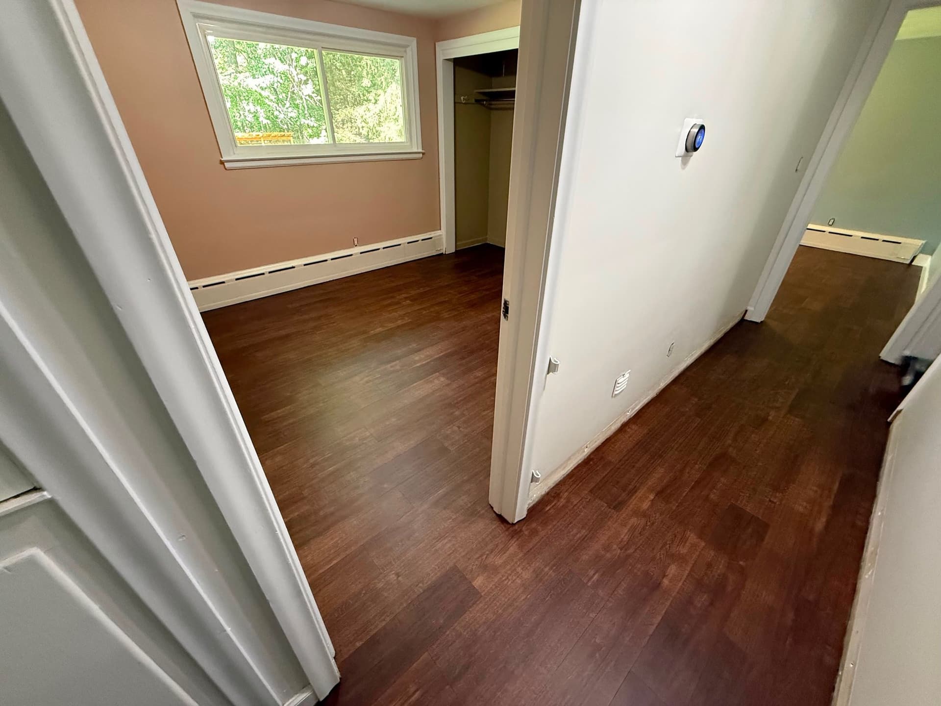 Karndean Opus Rubra gluedown luxury vinyl extending through a Berlin bedroom and hallway