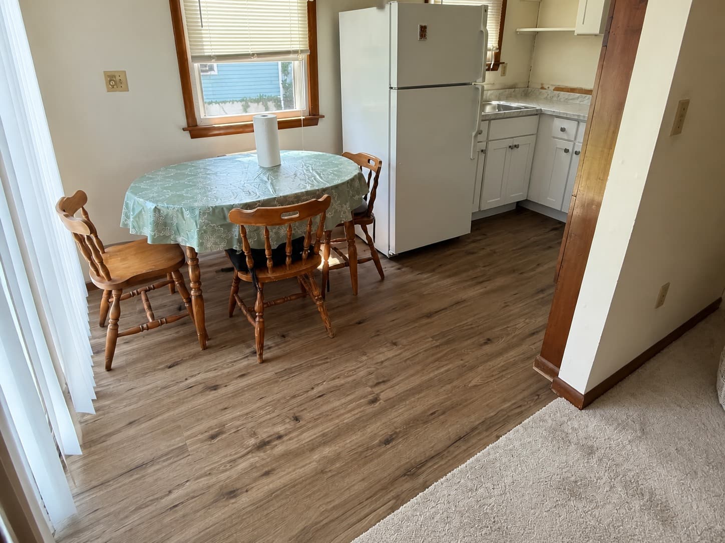 MSI Everlife Cyrus Fauna luxury vinyl plank installed in a Branford apartment kitchen beside the carpeted living room