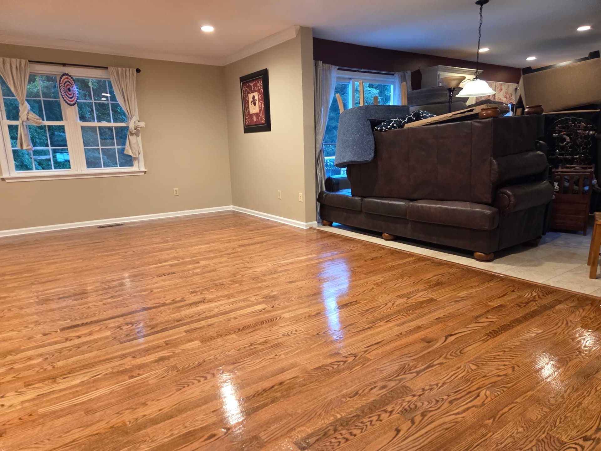 Sanded, stained, and finished hardwood flooring across a living area in a Monroe home