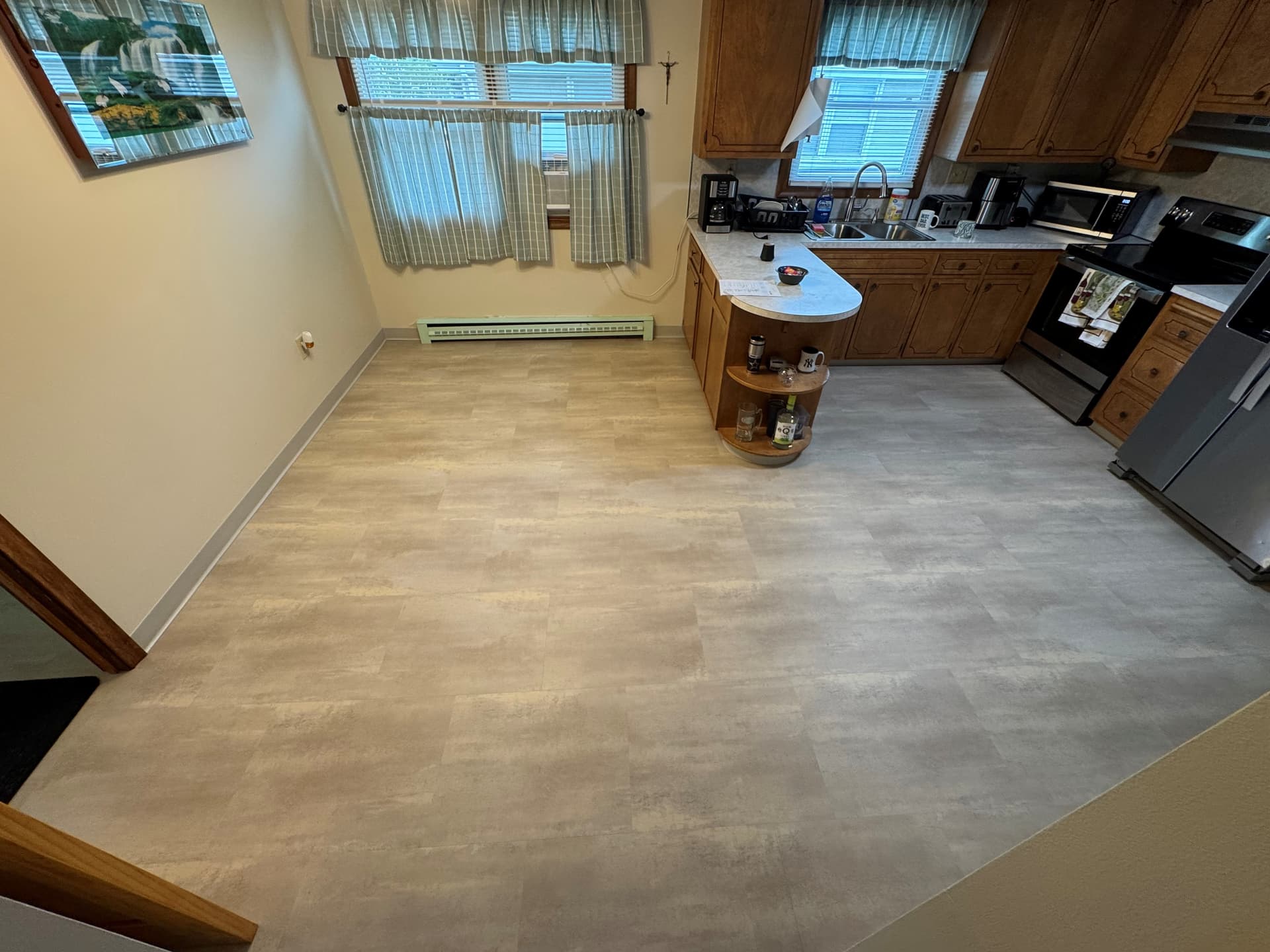 Karndean Opus Terra SP212 flooring installed across a New Britain kitchen with wood cabinets and gray cove base