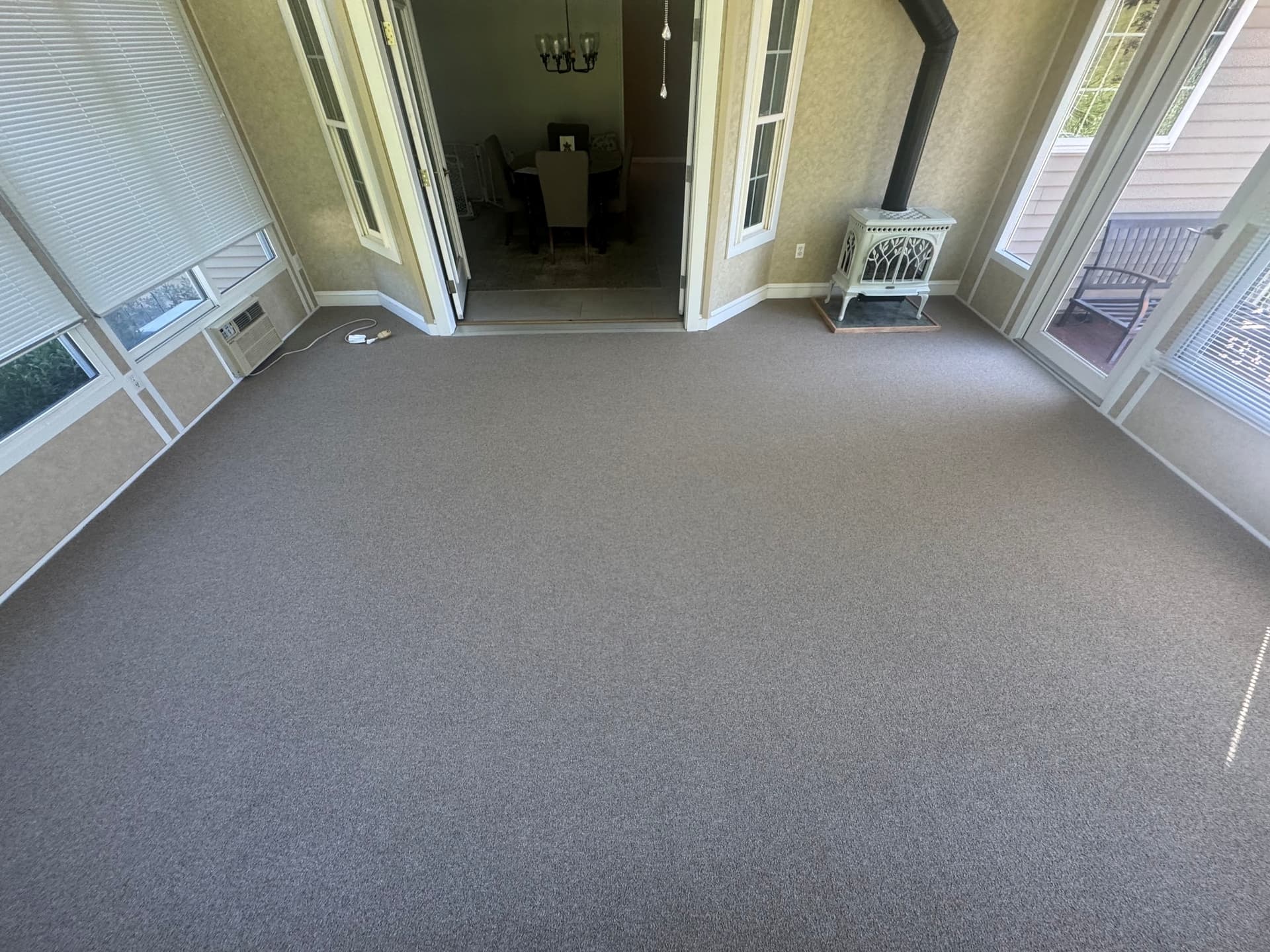 Philadelphia Profusion carpet in Bundle installed in a Newington sunroom with tall windows and a freestanding stove