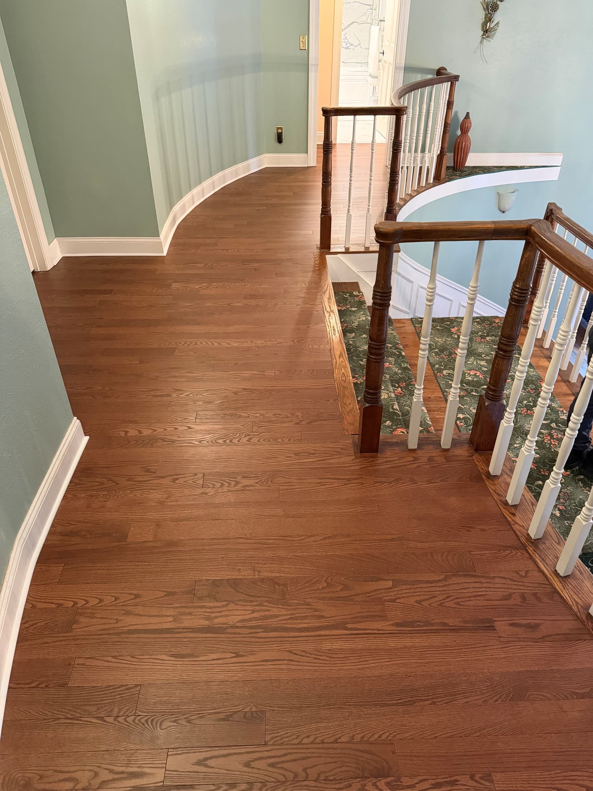 Red Oak Mackworth solid hardwood surrounding the carpeted stair opening on a Southington upstairs landing