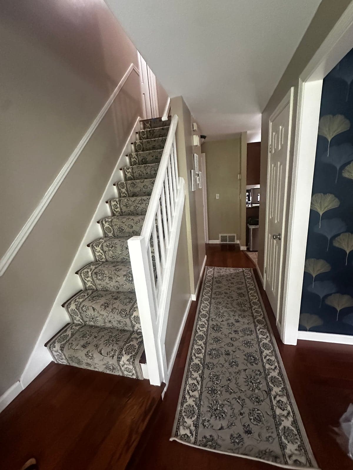 Ancient Garden Soft Grey runners installed waterfall style on a Vernon staircase and in the matching hallway