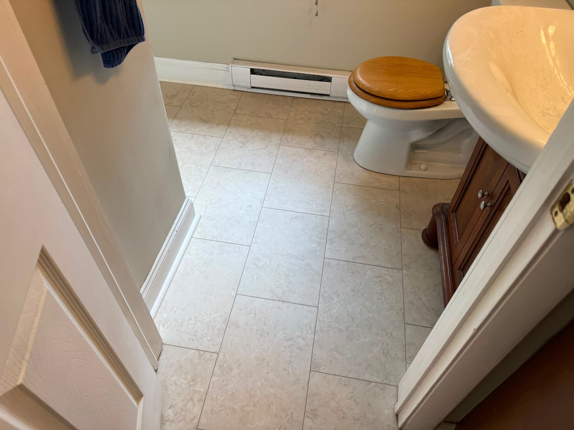 Limestone-look LVT fitted in a bathroom around a toilet and sink