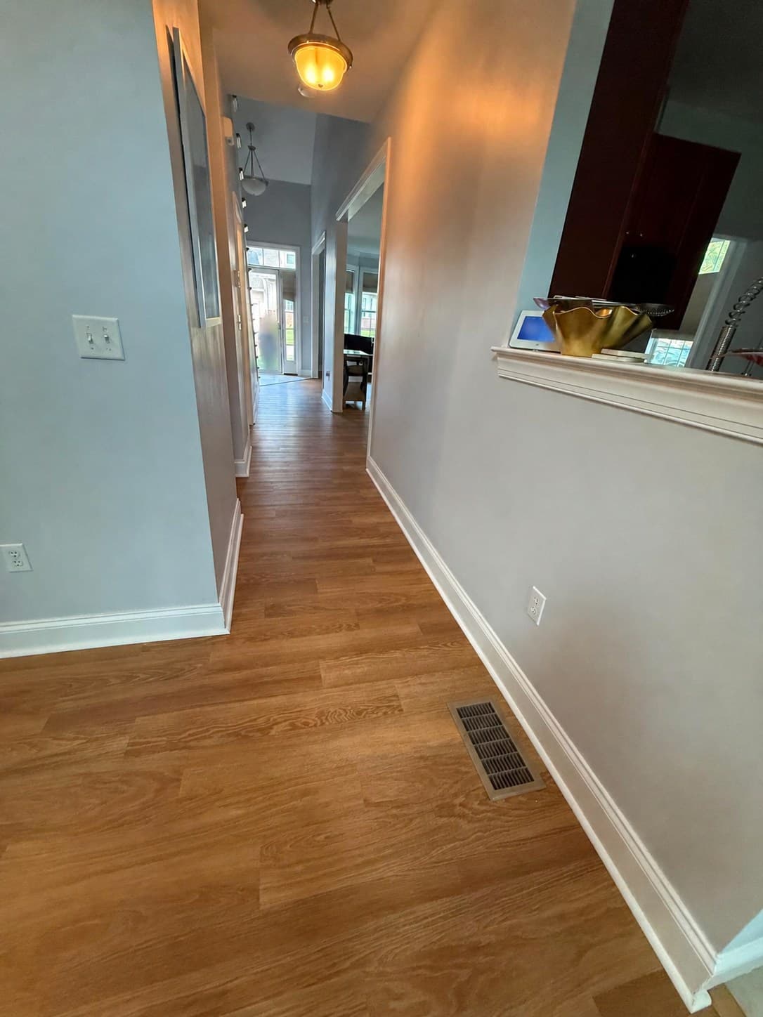 Karndean Honey Limed Oak click luxury vinyl flooring continuing through a downstairs hallway in a Windsor home